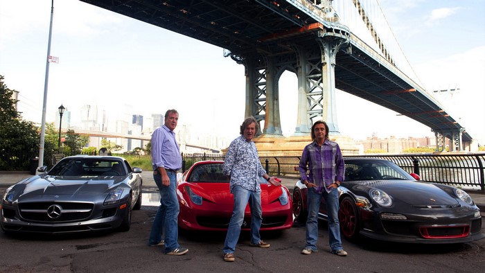 Jeremy Clarkson, Richard Hammond, and James May with cars under bridge