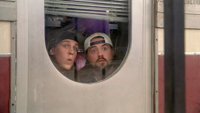 Jason Mewes and another man looking through a window