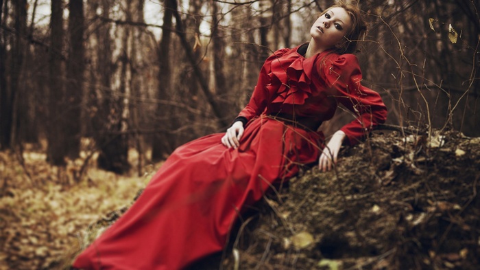 Woman in red dress in a forest