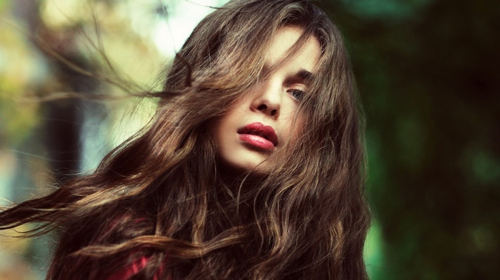 Woman with long brown hair and red lipstick