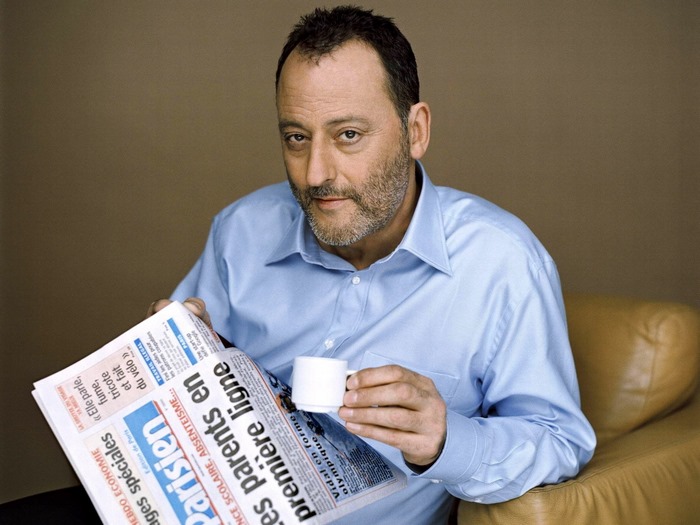 Jean Reno reading Parisien newspaper with coffee