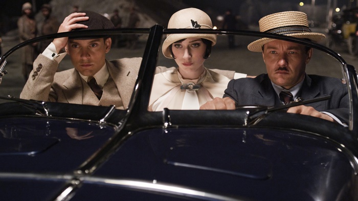 Joel Edgerton and two others in a vintage car