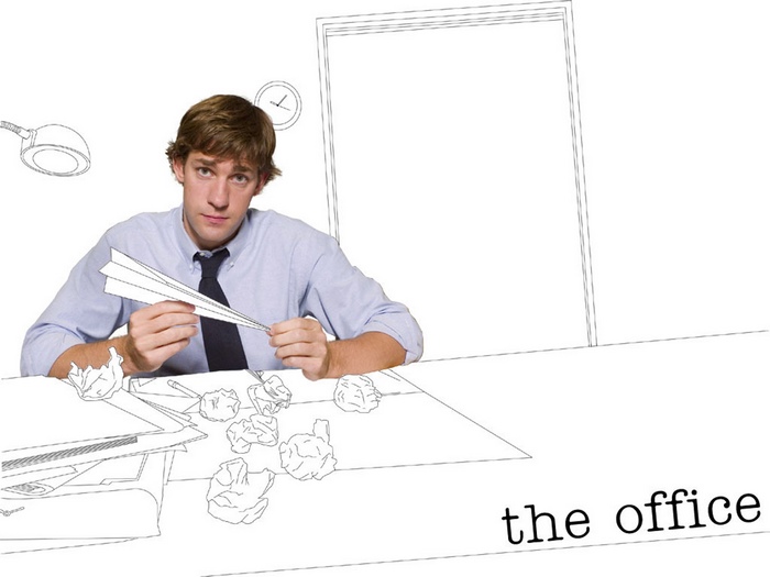 John Krasinski from The Office holding a paper airplane