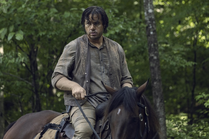 Josh McDermitt on horseback in a forest