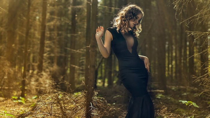 Woman in black dress in a forest