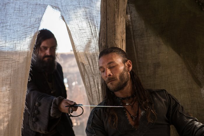 Ray Stevenson in a tent with a sword
