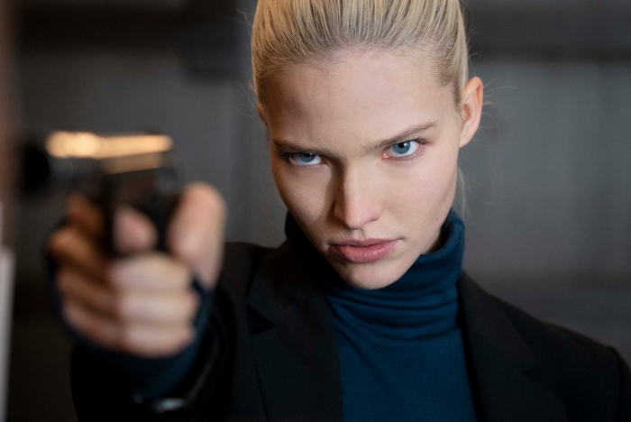 Sasha Luss holding a gun