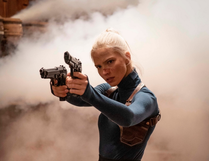 Sasha Luss holding two pistols