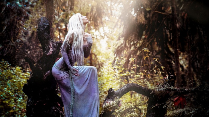 Woman with blonde hair in a forest