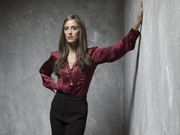 Kim Raver leaning against a wall