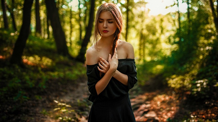 Woman in black dress in a forest