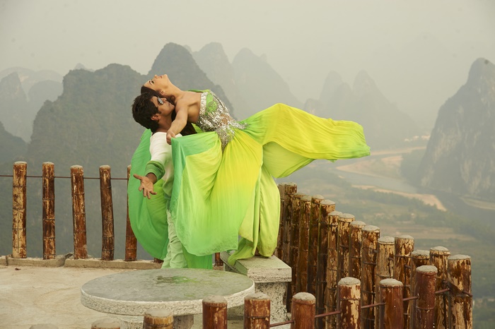 Amy Jackson dancing on a mountain viewpoint
