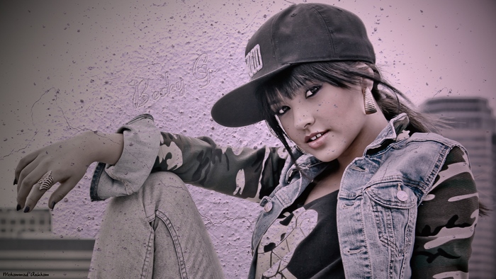 Becky G in a denim jacket and baseball cap