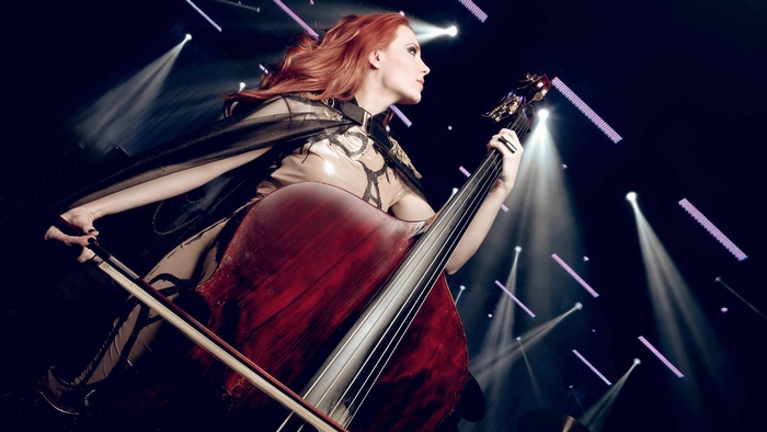 Simone Simons playing double bass on stage