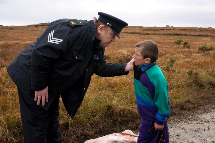 Brendan Gleeson as a police officer with a boy