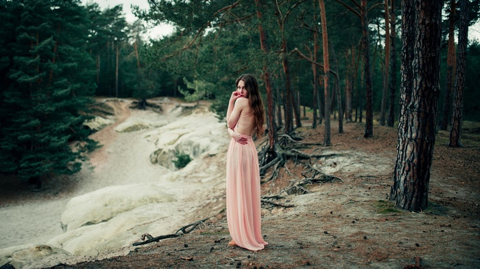 Woman in pink dress in a forest
