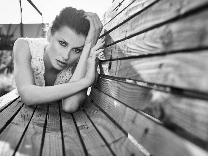 Bridget Moynahan on a wooden bench
