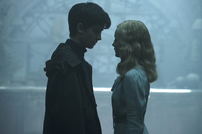 Ella Purnell in a blue dress and a young man in a dark coat