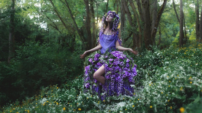 Woman in a floral dress in a forest
