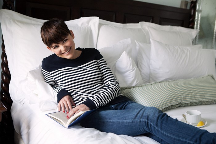 Ginnifer Goodwin reading a book in bed