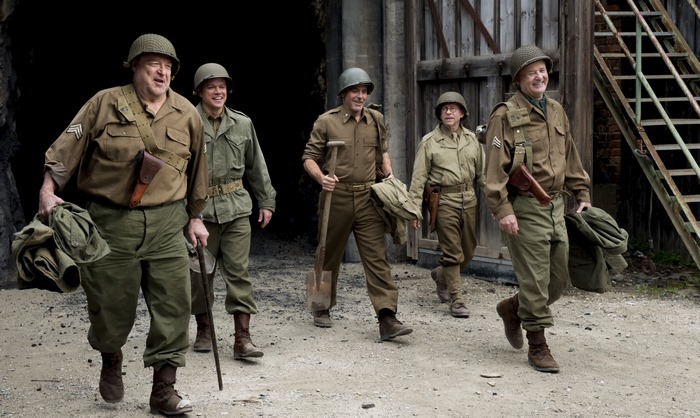 John Goodman and soldiers in military uniforms