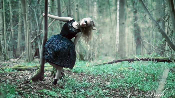 Woman in black dress in a forest