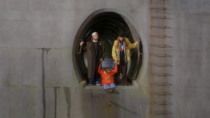 Kevin Smith and Jason Mewes with a child
