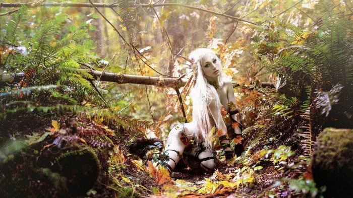 Woman in forest with leaves and ferns