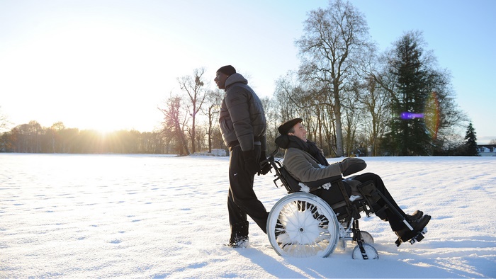 Omar Sy in a wheelchair in the snow