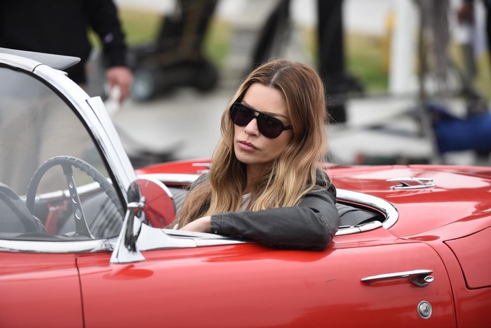 Lauren German in a red convertible