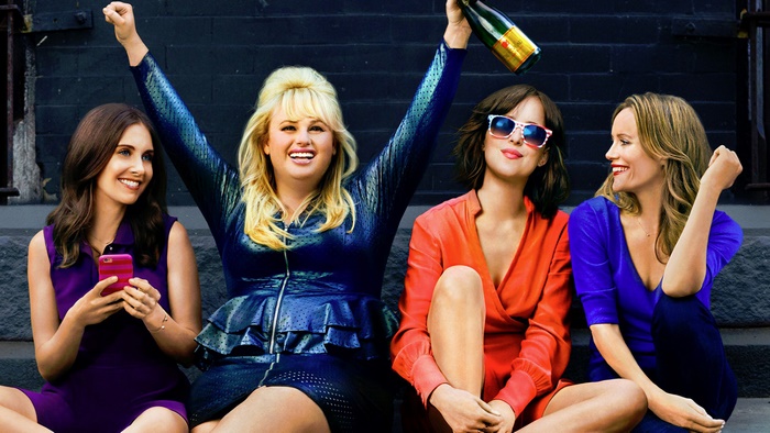 Four women celebrating with champagne