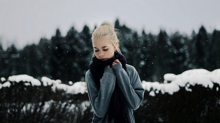 Girl in a scarf in the snow