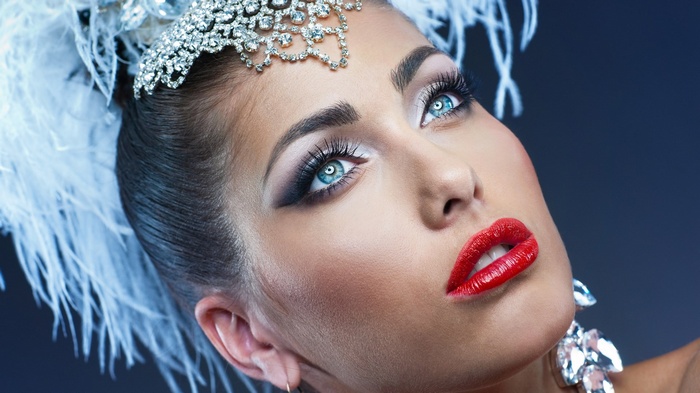 Woman with elaborate makeup and headdress