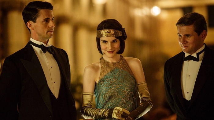 Michelle Dockery and two men in tuxedos