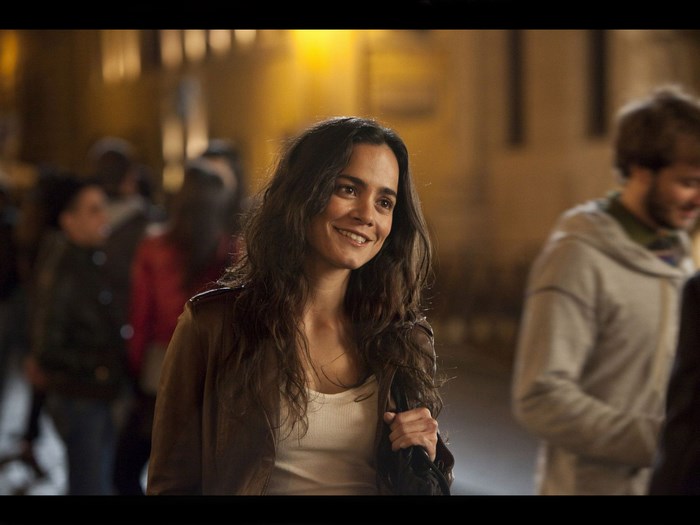 Alice Braga smiling at night