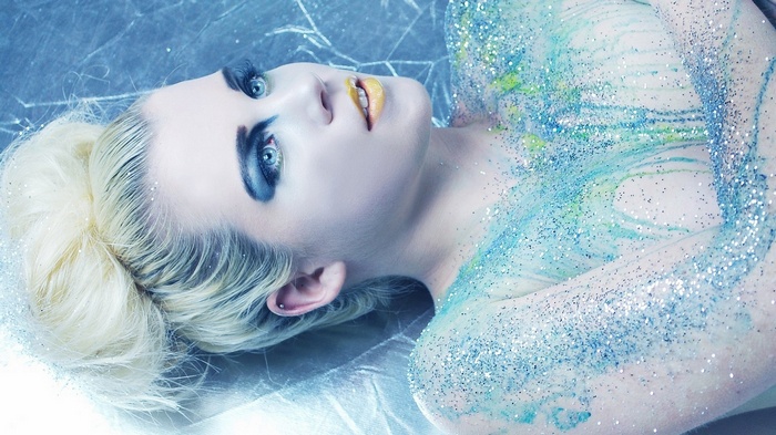 Woman with glitter and dramatic makeup