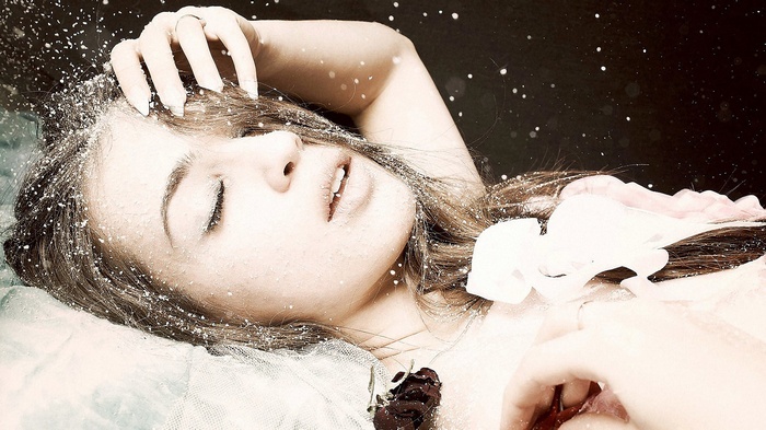 Woman covered in snow with a rose