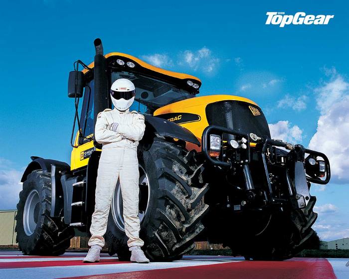 Ben Collins in a racing suit with a JCB tractor