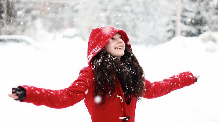 Girl in red coat in the snow
