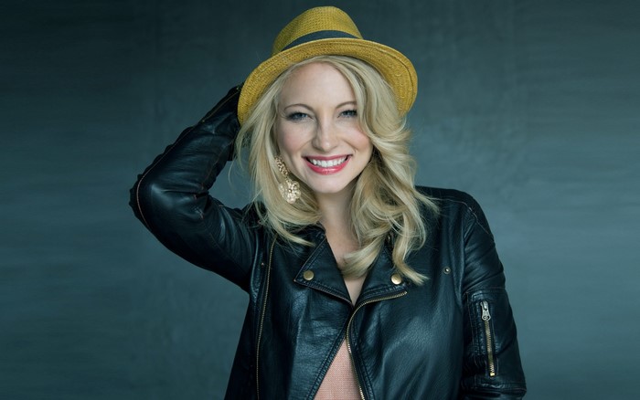 Candice King wearing a hat and leather jacket