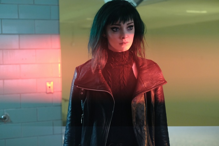 Emma Dumont in a black leather jacket