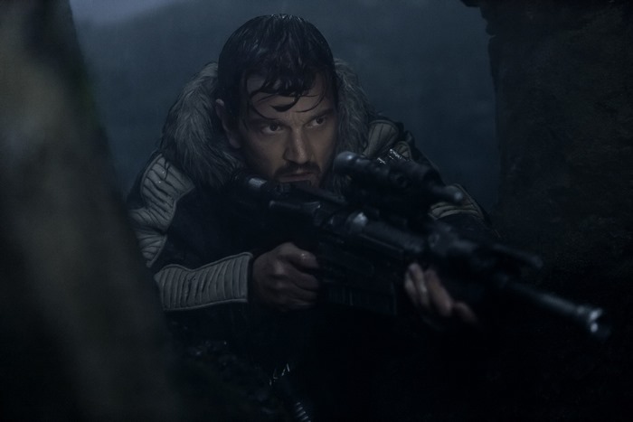 Diego Luna as Cassian Andor with a blaster rifle
