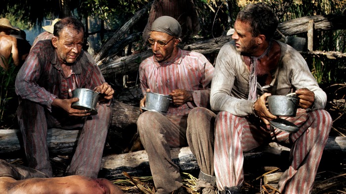 Prisoners eating from metal bowls