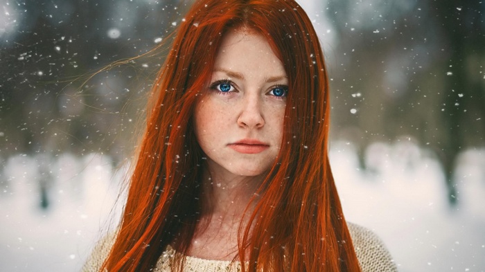 Woman with red hair in the snow
