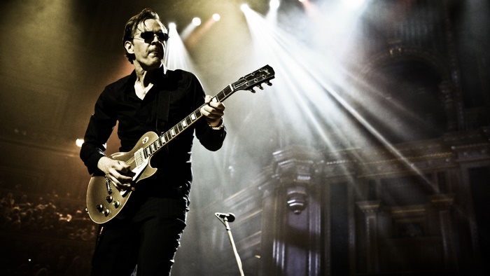 Joe Bonamassa playing guitar on stage