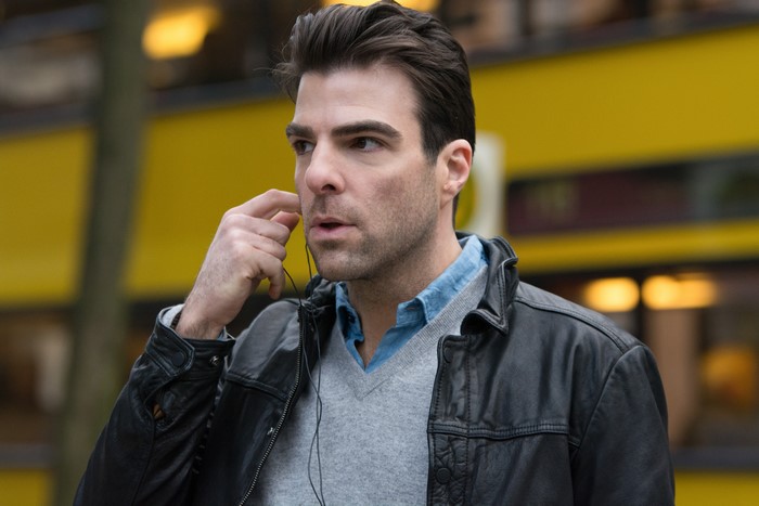 Man wearing a leather jacket and earphones