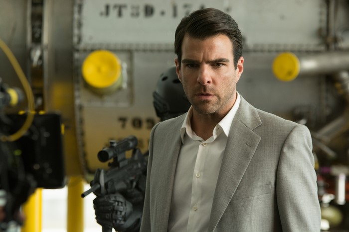 Man in a suit with a gun
