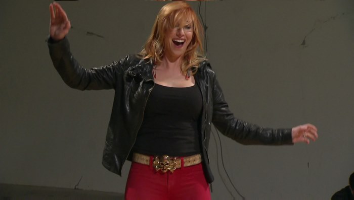 Kari Byron with arms raised