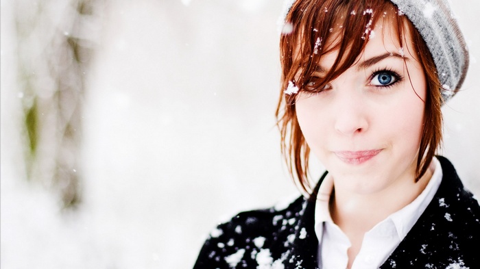 Young woman with blue eyes in the snow