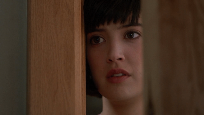 Phoebe Cates peeking through a doorway